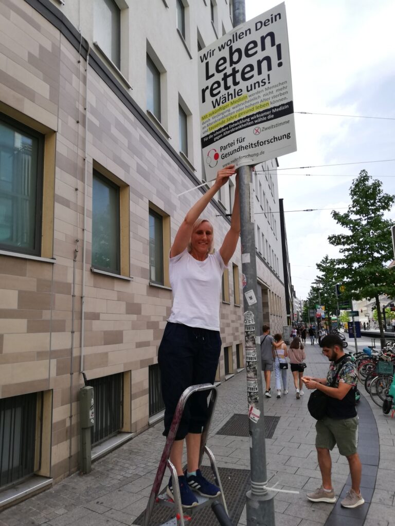 Wiebke Holst putting up posters